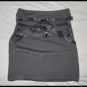 Black form fitting mini skirt with buckles